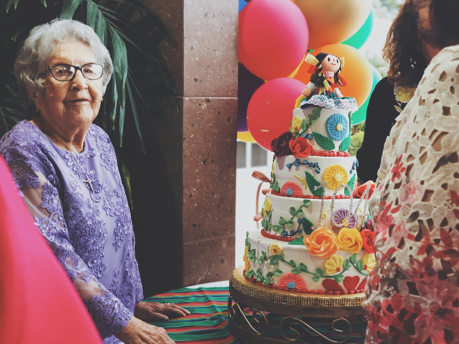 Older woman at a colourful birthday celebration
